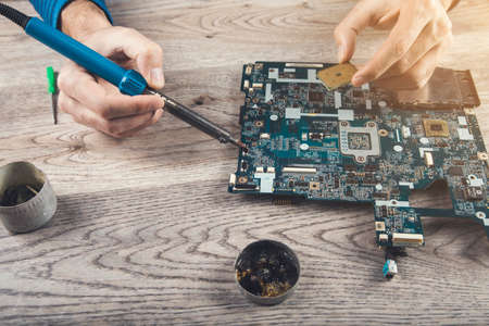 computer part repair. Closeup of disassembled motherboard