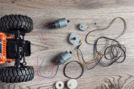 Small electric motors and toy car on table