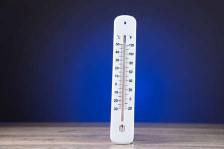 thermometer on the desk on blue background