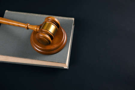 Judge gavel with books on the black tableの写真素材
