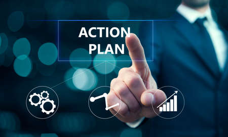 business man touching action plan in screenの写真素材