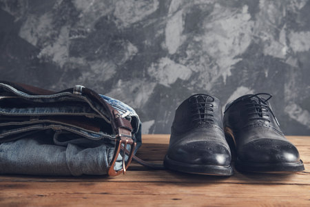 jeans with belt and shoes on wooden backgroundの写真素材