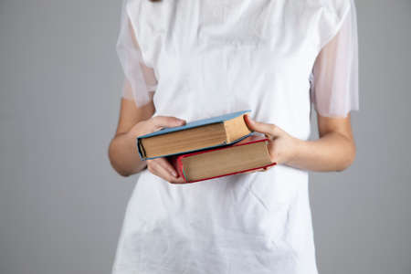young woman holding booksの写真素材