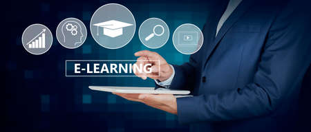 Businessman holding a tablet pc with E-learning text on virtual screen. business concept.
