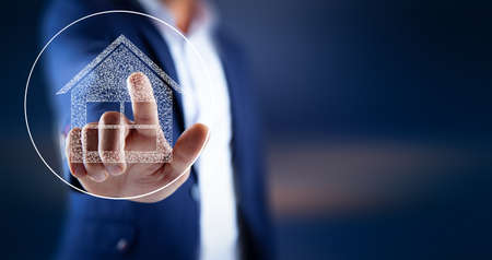 hand touch the house icon for sale rent insurance conceptの写真素材