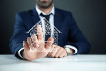 hand touch the house icon for sale rent insurance conceptの写真素材