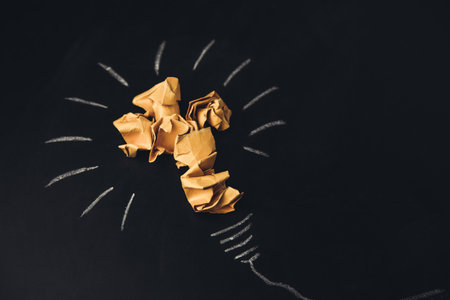 Inspiration concept crumpled paper light bulb on boardの写真素材