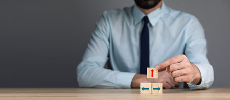 business man holding cubes with arrowの写真素材
