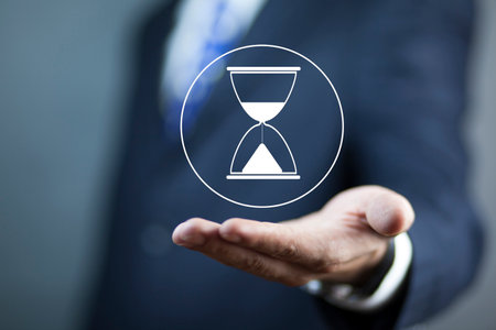 the business man holding hourglass icon.