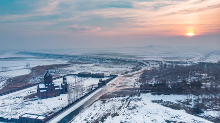 Church with snowy landscape view from a drone at the sunsetの写真素材