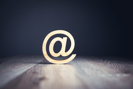 Wooden email Symbol on the wooden tableの写真素材