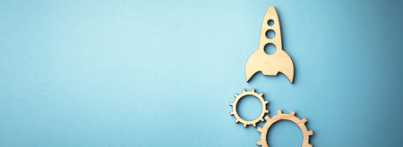 wooden rocket with gears on the blue background
