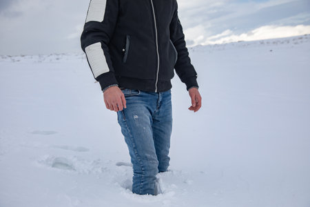 A young man through the snow.の写真素材