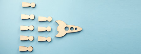 wooden rocket with people on blue background