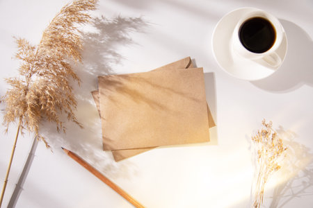 letters with grass decoration and cup of coffee on the table