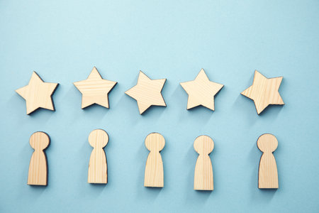 wooden five stars and people sign on blue backgroundの写真素材