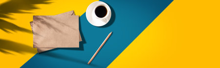 letters and pencil with cup of coffee on the color backgroundの写真素材