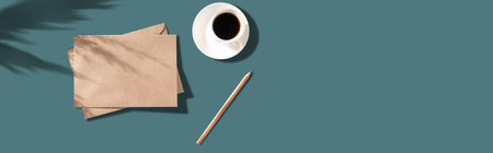 letters and pencil with cup of coffee on the blue backgroundの写真素材