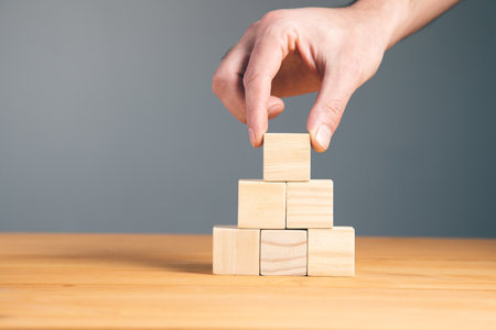 Hand holding blank wooden block cubes, business concept background.の写真素材