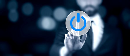 Hand of the businessman pressing power buttonの写真素材