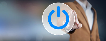 Hand of the businessman pressing power button