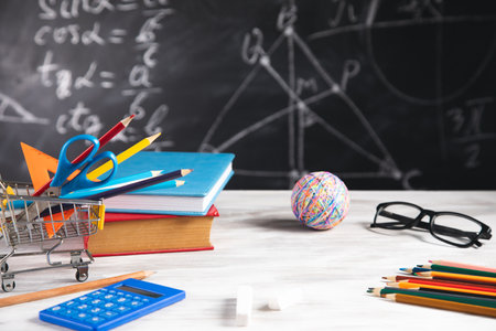 School supplies on the wooden background.