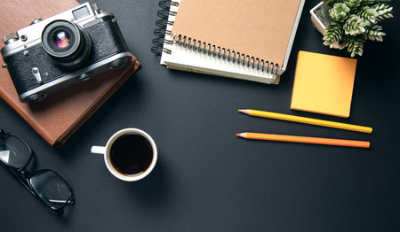 vintage camera on notepad with cup of coffeeの写真素材