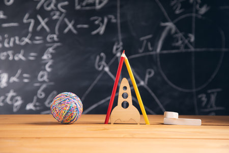 Back to school concept. rocket and pencils in front of classroom blackboard