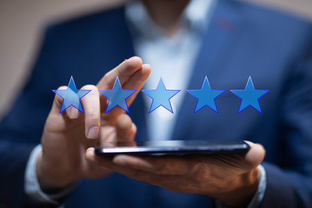 man holding smart phone with five star icon