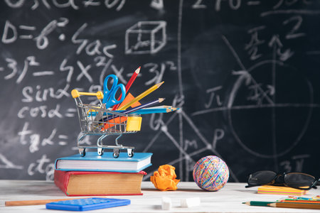 different stationary with books on blackboard background