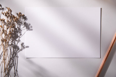 mockup cards with flower and pencil on tableの写真素材