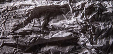Dark gray crumpled paper texture background.の写真素材