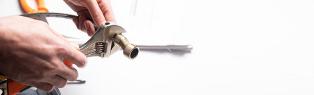 worker plumber hands screwing nut of pipeの写真素材