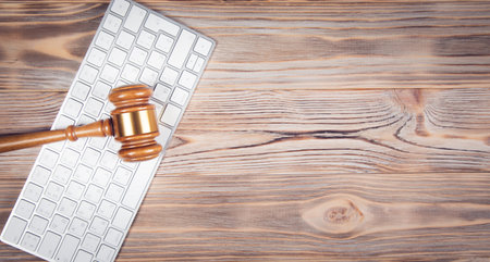 Judge gavel with computer keyboard. Concept of internet crime.の写真素材
