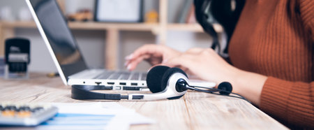business woman with earphone and computer on the table