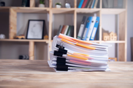pile of documents on desk in officeの写真素材