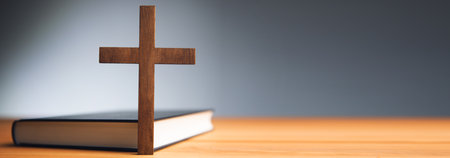 wooden cross with Holy Bible on the tableの写真素材