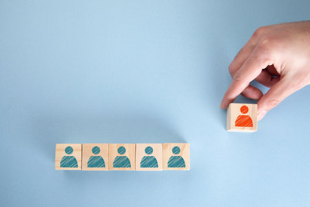 man holding leader on wooden cubes