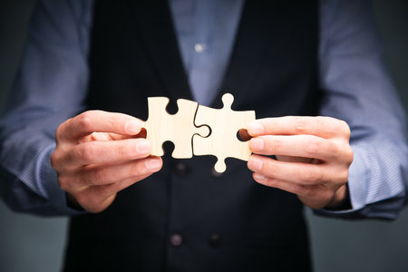 business man hands connecting puzzle piecesの写真素材