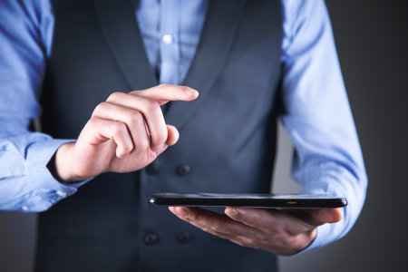Mock up of a man holding digital tablet device in handsの写真素材