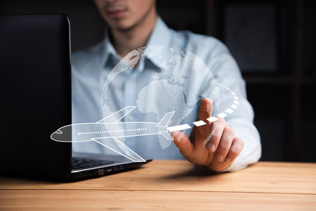 business man working computer with airplane and mapの写真素材