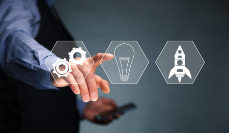 business man holding phone with start up icon