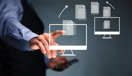 business man holding phone with transfer files iconの写真素材