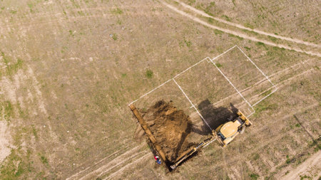The tractor digs the foundation of the houseの写真素材