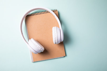 white earphone on notepad on the tableの写真素材