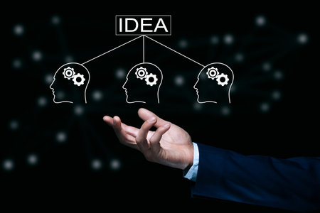 business man holding idea and people gears iconの写真素材