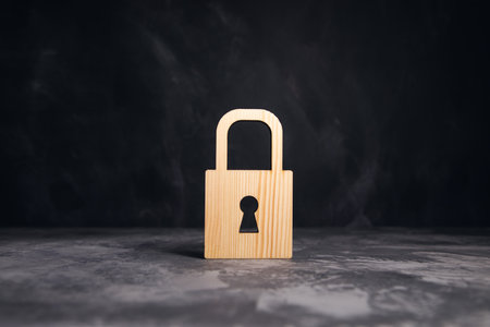 wooden lock on the gray table backgroundの写真素材