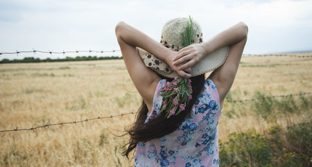 young woman holding flowers in the gardenの写真素材