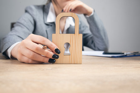 person privacy and security concept. woman holding wooden lock