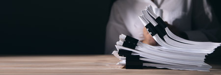 business woman holding stack of documents